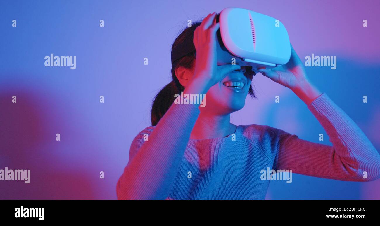 Woman watching with VR device Stock Photo