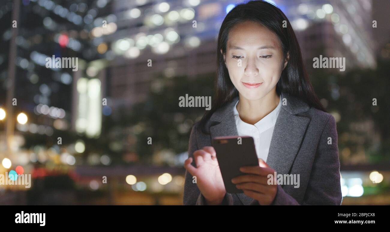 Asian business woman use of smart phone in Hong Kong Stock Photo - Alamy