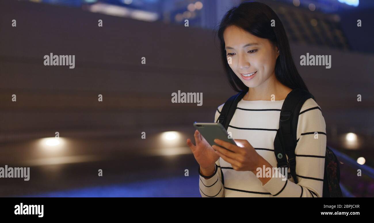 Woman use of smart phone in Hong Kong at night Stock Photo - Alamy