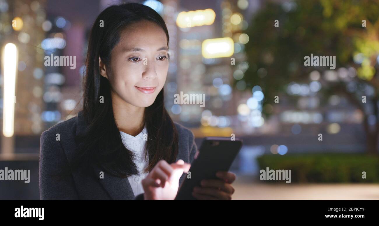 Asian businesswoman use of mobile phone at night Stock Photo - Alamy