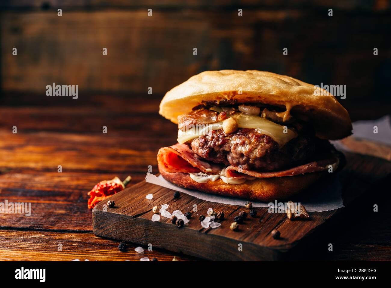 The Casanova Burger on Cutting Board. Cheeseburger with Beef Patty