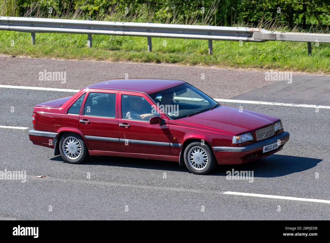 1994 red Volvo 850 S Auto saloon;  Vehicular traffic moving vehicles, driving vehicle on UK roads, motors, motoring on the M6 motorway highway Stock Photo