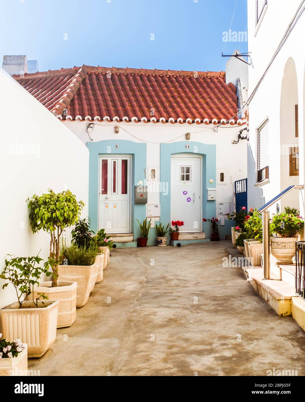 Courtyard decorated with plants in pots in Almada, Portugal. Stock Photo