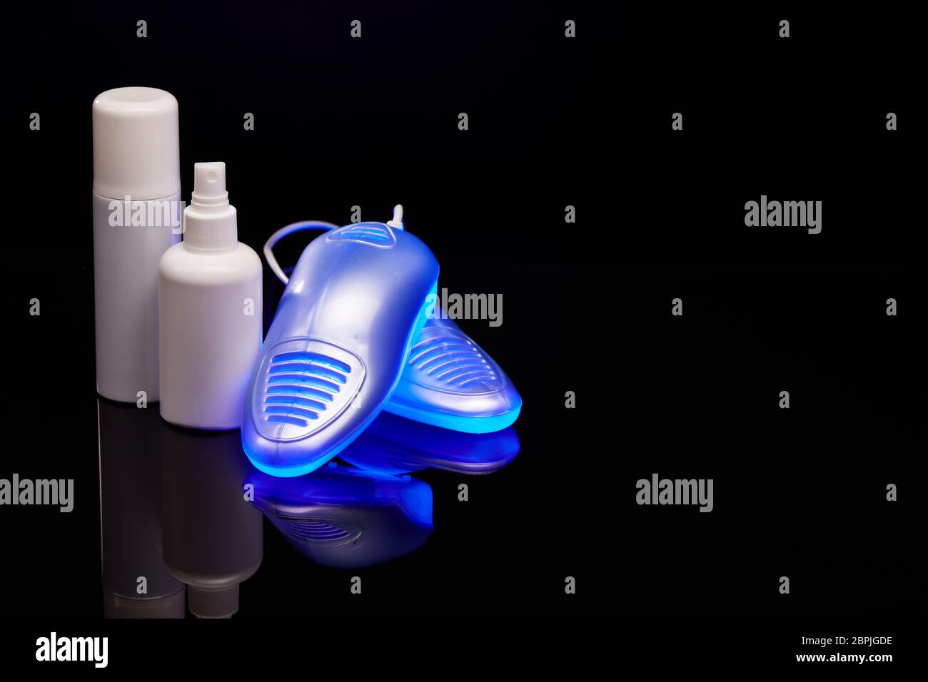 Electric shoes dryer with UV sterilization on a black background with