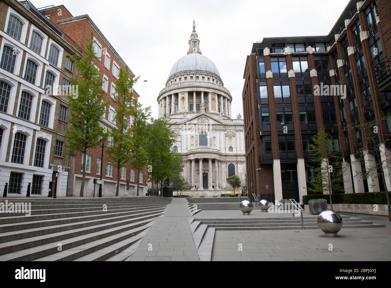 View looking towards St Pauls Cathedral is eerily quiet and silent aside from a few pedestrians on empty streets as lockdown continues and people observe the stay at home message in the capital on 11th May 2020 in London, England, United Kingdom. Coronavirus or Covid-19 is a new respiratory illness that has not previously been seen in humans. While much or Europe has been placed into lockdown, the UK government has now announced a slight relaxation of the stringent rules as part of their long term strategy, and in particular social distancing. Stock Photo