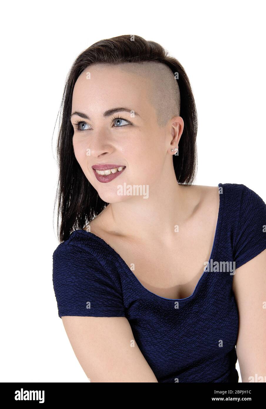 A beautiful young woman in a close up image with short black hair shaved on one  side, looking up, isolated over white background Stock Photo - Alamy