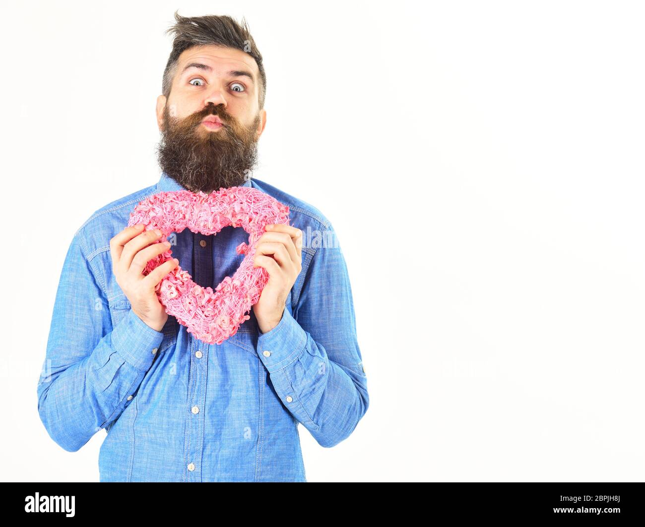 Stupid love concept. Hipster with stupid face holds symbol of love Stock Photo
