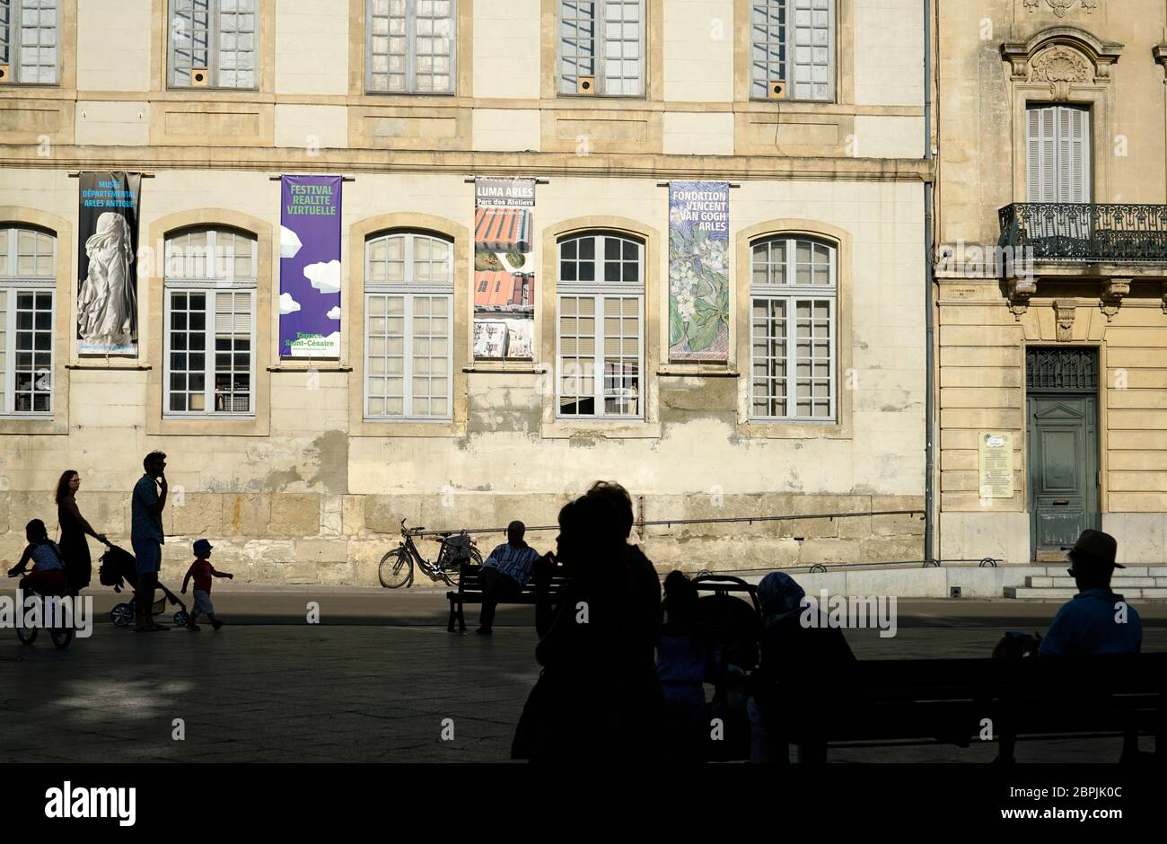 Silhouettes of people in Place de la Republique with Episcopal Palace in the background.Arles.Bouches-du-Rhone.Alpes-Cote d'Azur.France Stock Photo