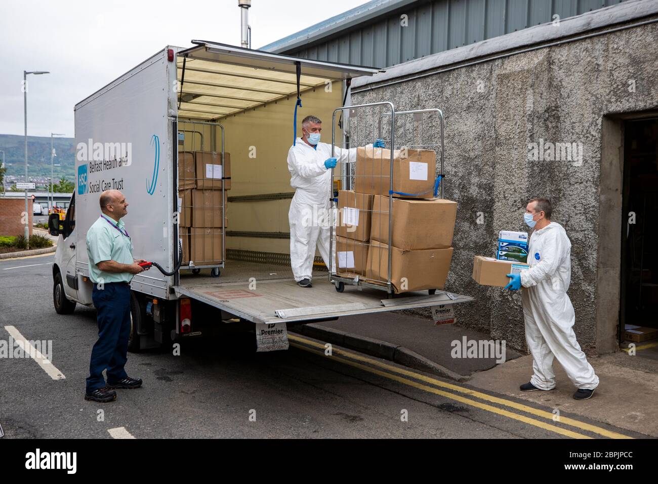 Workers at the Belfast Trust PPE store load PPE to be delivered to departments around the trust. The store is located on the grounds of Belfast City Hospital. Stock Photo