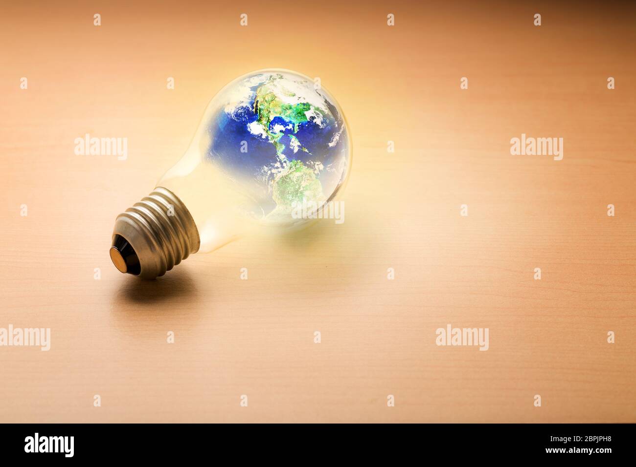 Light bulb with the world on wooden background, old idea can save world concept, Earth day concept, Elements of this image furnished by NASA Stock Photo