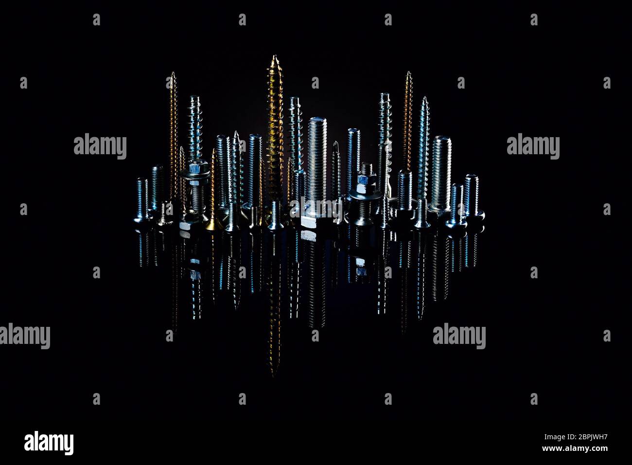 The city at night from small screws and bolts. Advertising photo of materials and products for construction. Stock Photo
