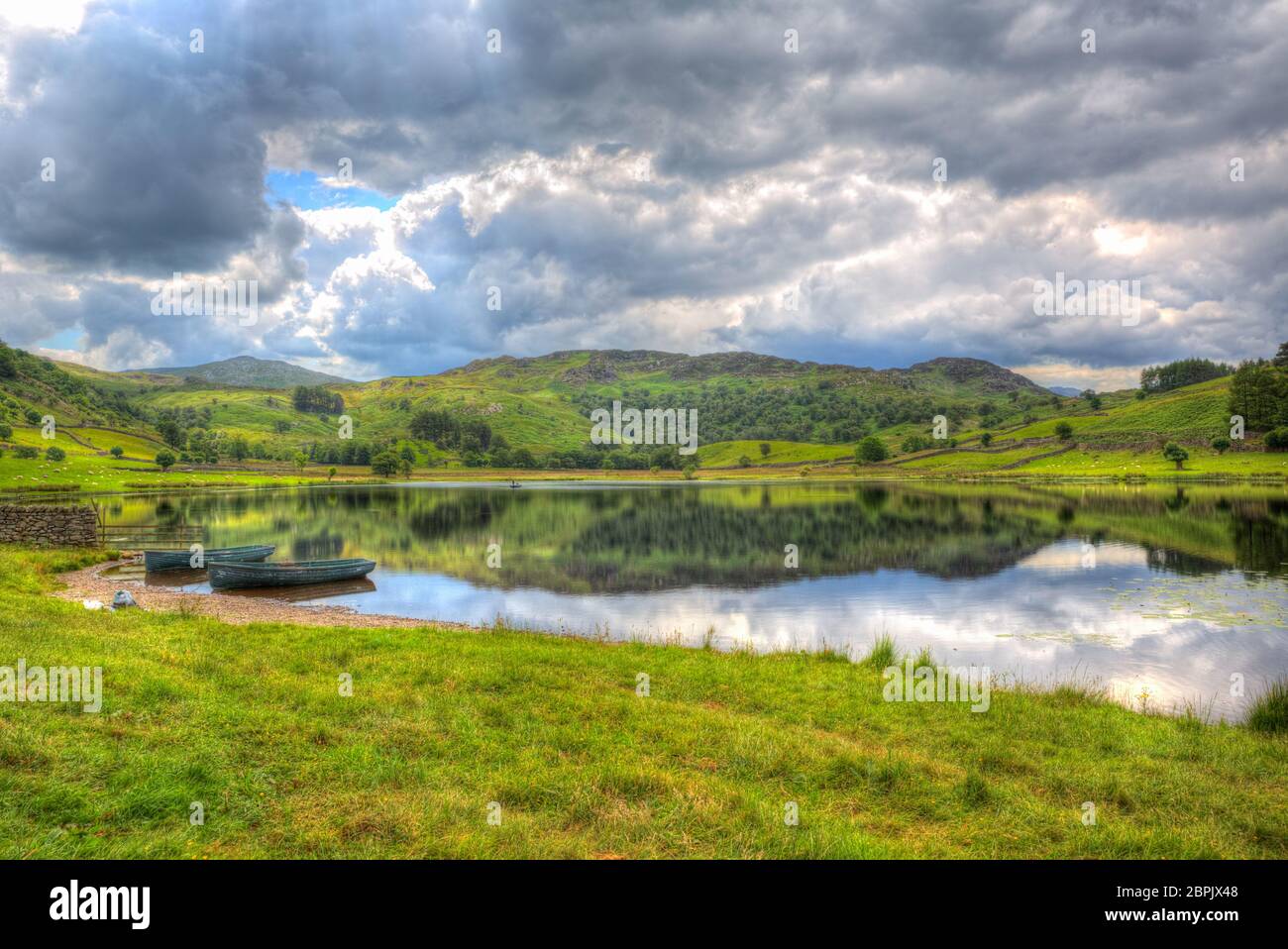 Beautiful lake with boats Watendlath Tarn The Lakes Cumbria England in hdr Stock Photo