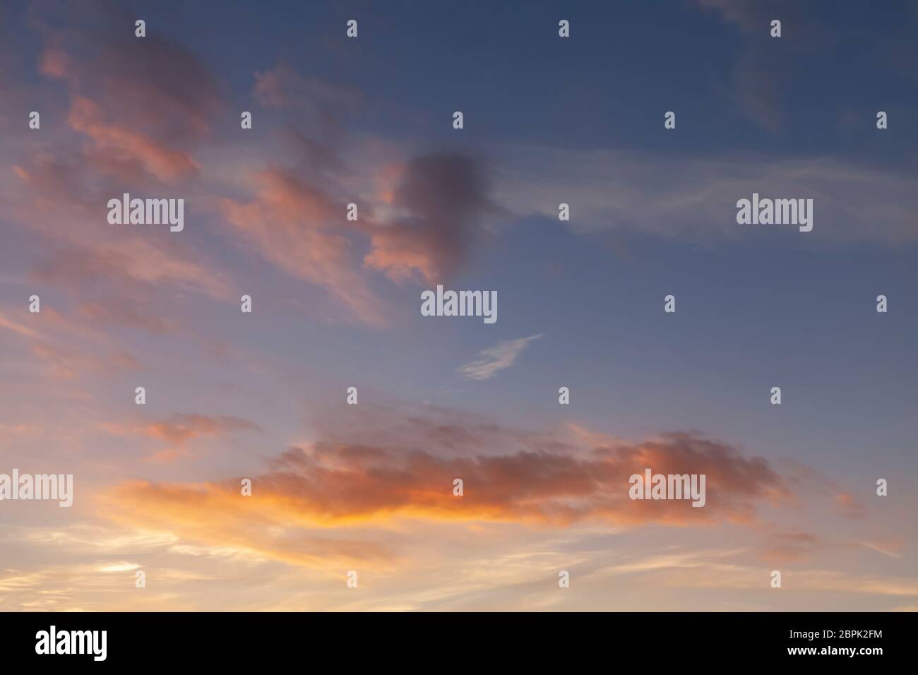 Sunset sky and pink clouds with a blue background sky Stock Photo - Alamy