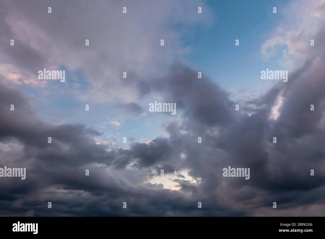 Unusual cloudy skies with dramatic grey clouds with some blue sky. Stock Photo