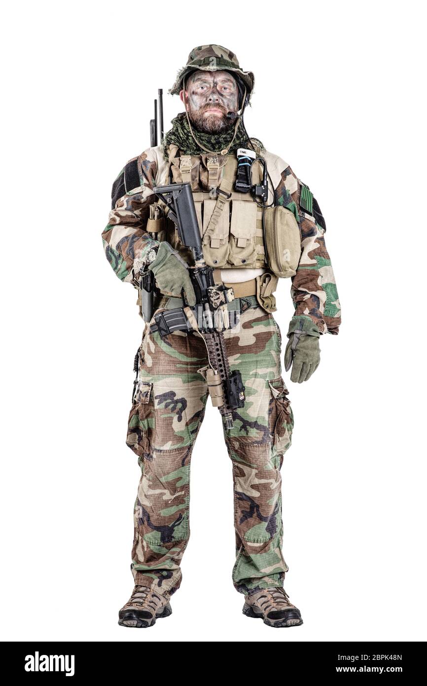 Special forces United States in Camouflage Uniforms studio shot. Holding weapons, wearing jungle hat, Shemagh scarf, painted face, his outfit clothes Stock Photo