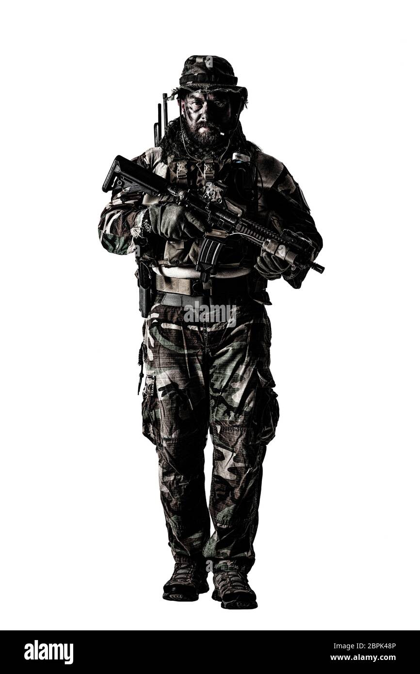 Special forces United States in Camouflage Uniforms studio shot. Holding weapons, wearing jungle hat, Shemagh scarf, painted face, his outfit clothes Stock Photo