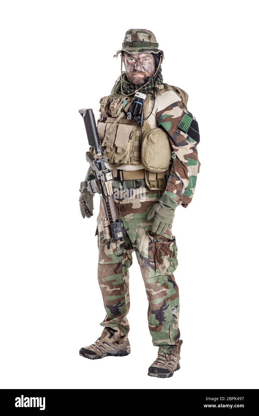 Special forces United States in Camouflage Uniforms studio shot. Holding weapons, wearing jungle hat, Shemagh scarf, painted face, his outfit clothes Stock Photo