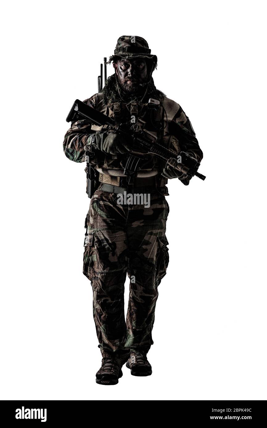 Special forces United States in Camouflage Uniforms studio shot. Holding weapons, wearing jungle hat, Shemagh scarf, painted face, his outfit clothes Stock Photo