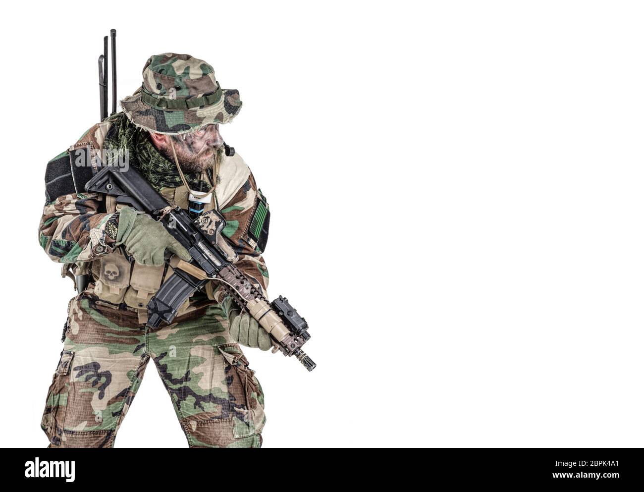 Special forces United States in Camouflage Uniforms studio shot. Holding weapons, wearing jungle hat, Shemagh scarf, painted face, his outfit clothes Stock Photo