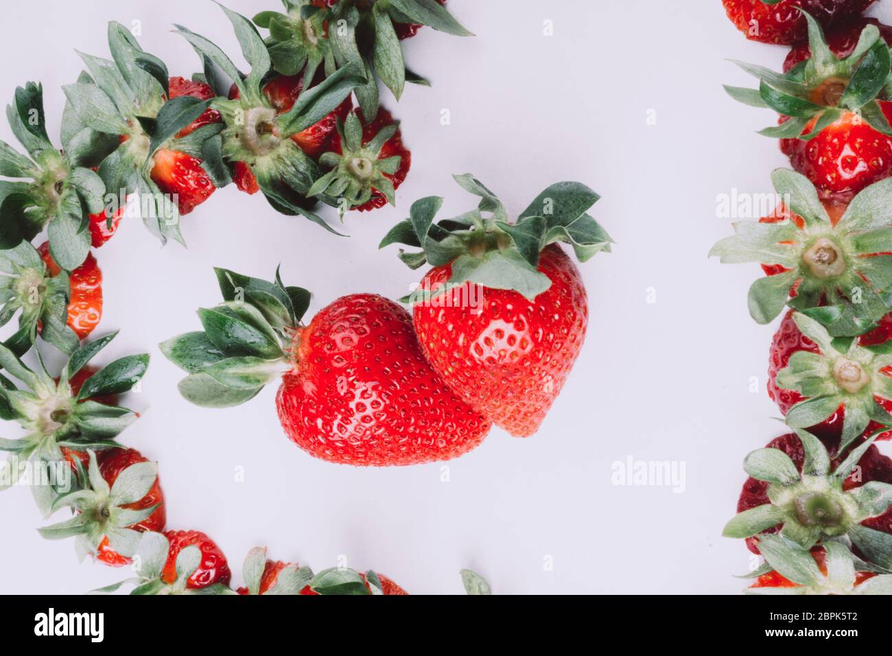 ripe red whole fresh strawberries with green stalks , view from above ...