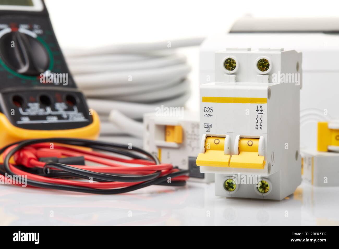 Automatic circuit breakers, distribution box, cable and digital tester on a white background. Electrical equipment. Accessories for electrical  protec Stock Photo