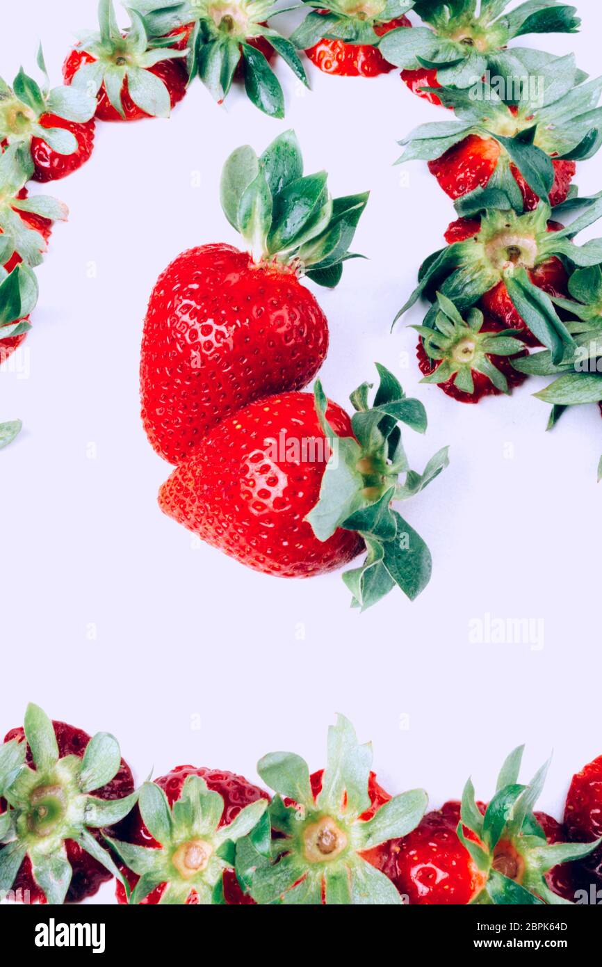 ripe red whole fresh strawberries with green stalks , view from above ...
