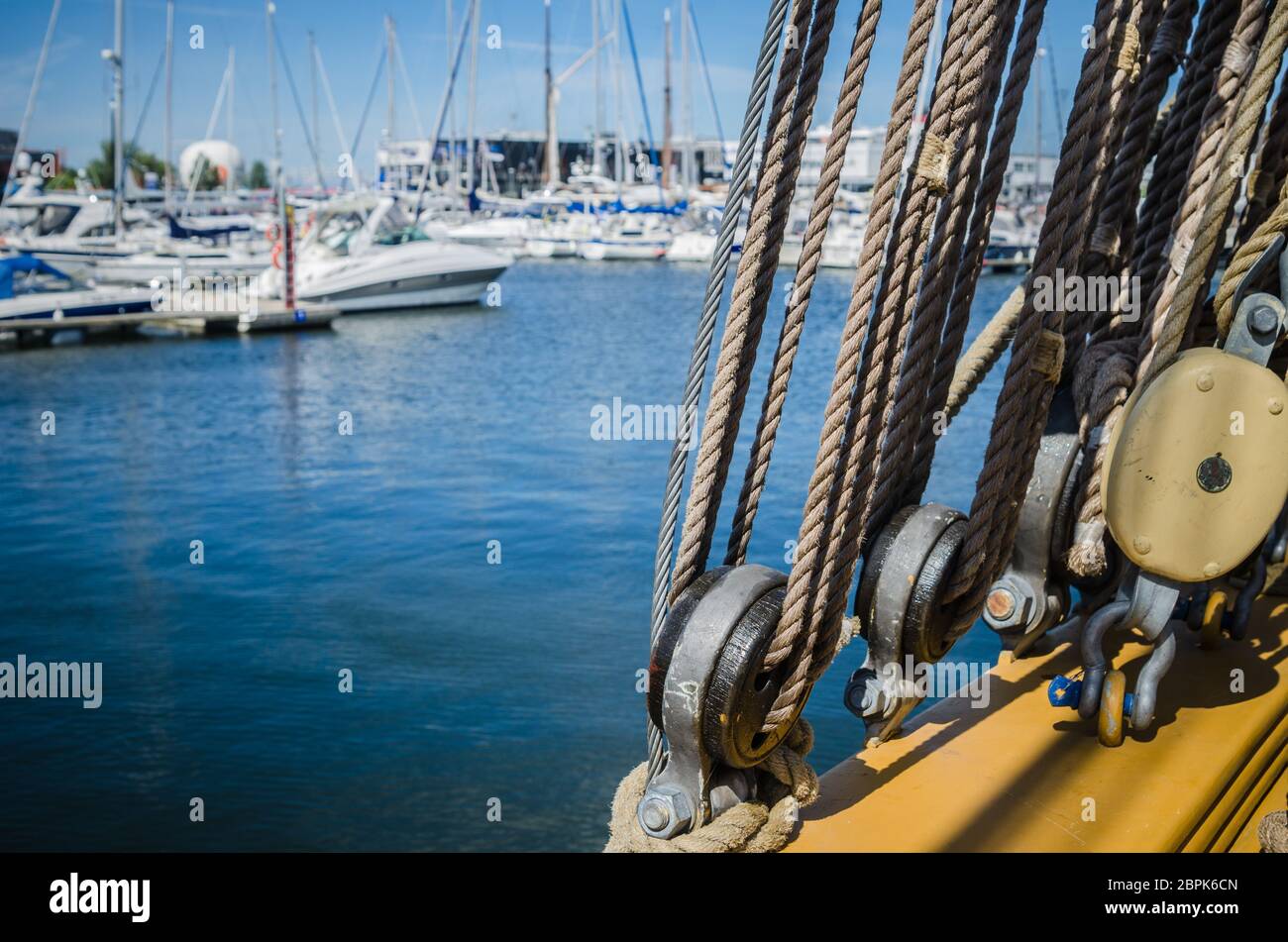 Rigging on the old sailboat against the background of modern yachts ...