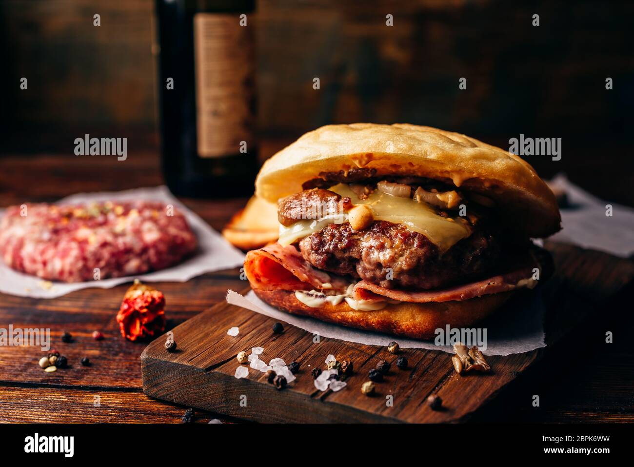 Homemade Burger on Cutting Board. Cheeseburger with Beef Patty