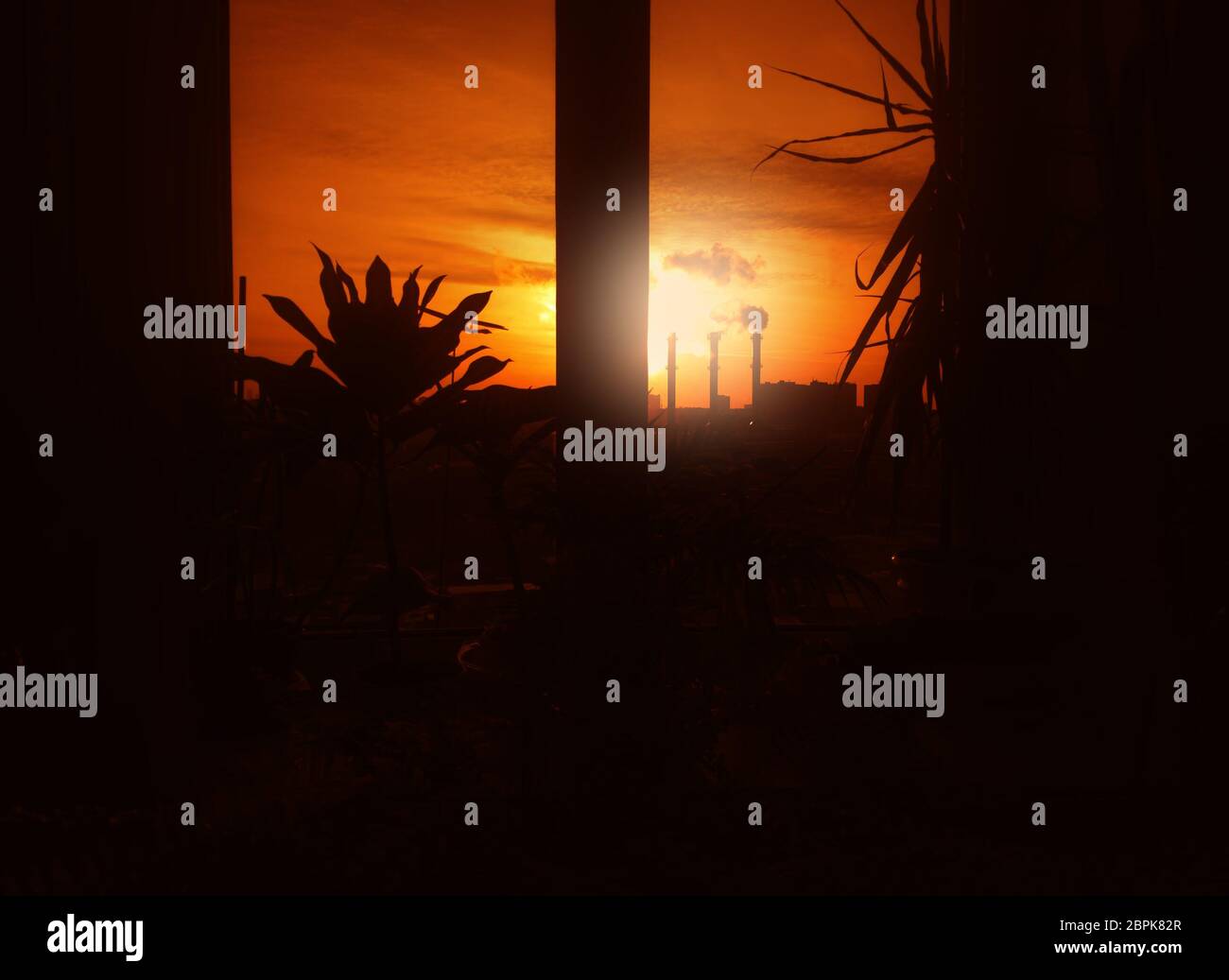 Dramatic industrial sunset through the office window background Stock Photo