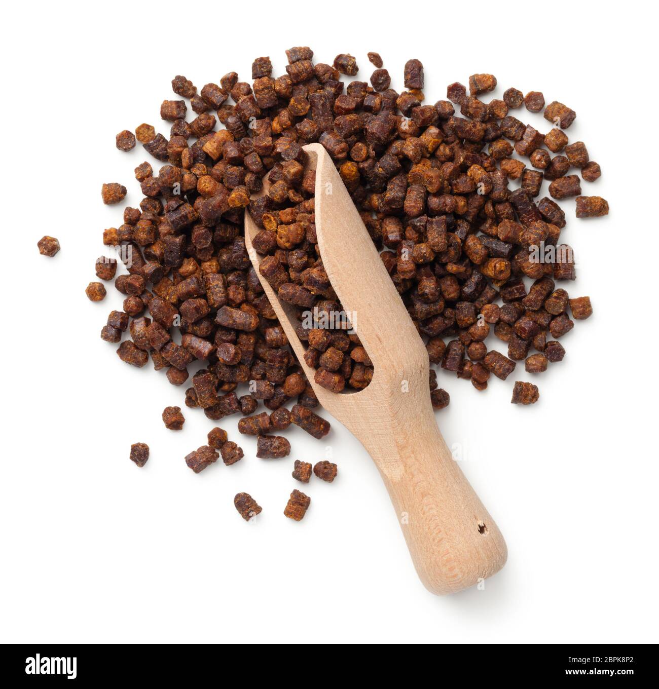 Bee pollen propolis in wooden scoop isolated on white background. Top ...