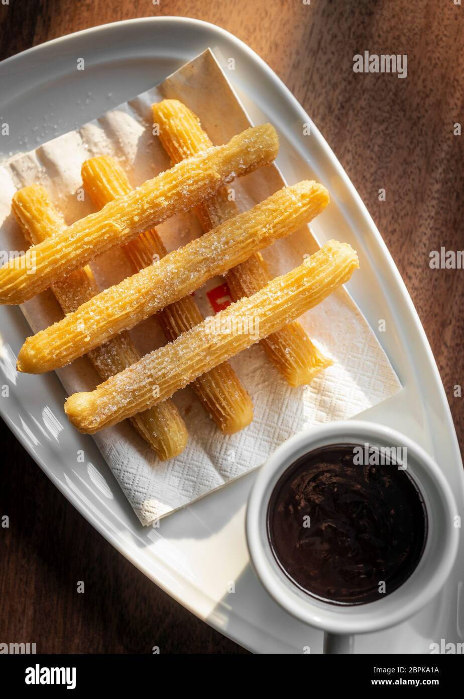 churros con chocolate traditional spanish sweet breakfast set on wooden table Stock Photo