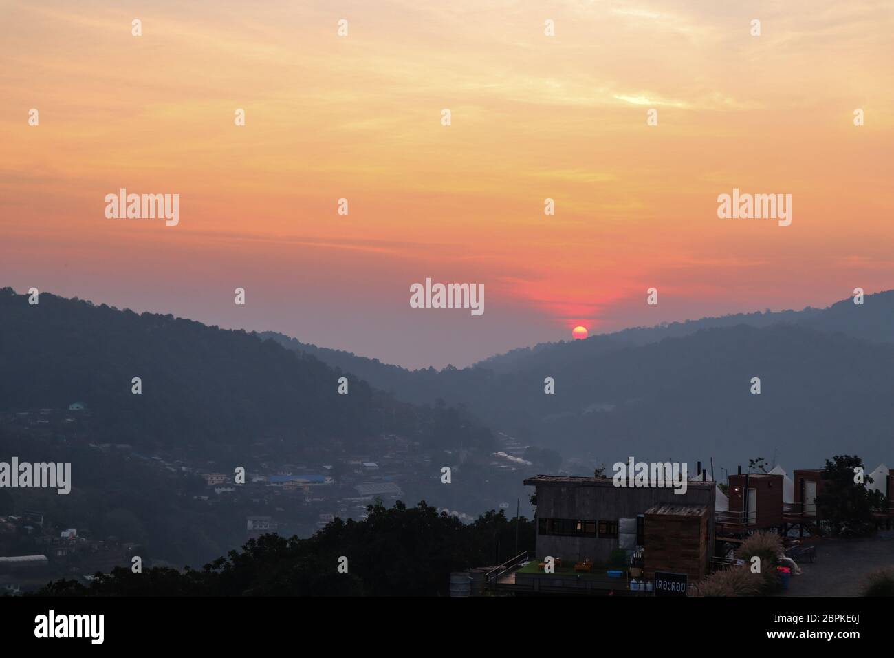 Colorful sunset over the mountain hills in a thai village near ...