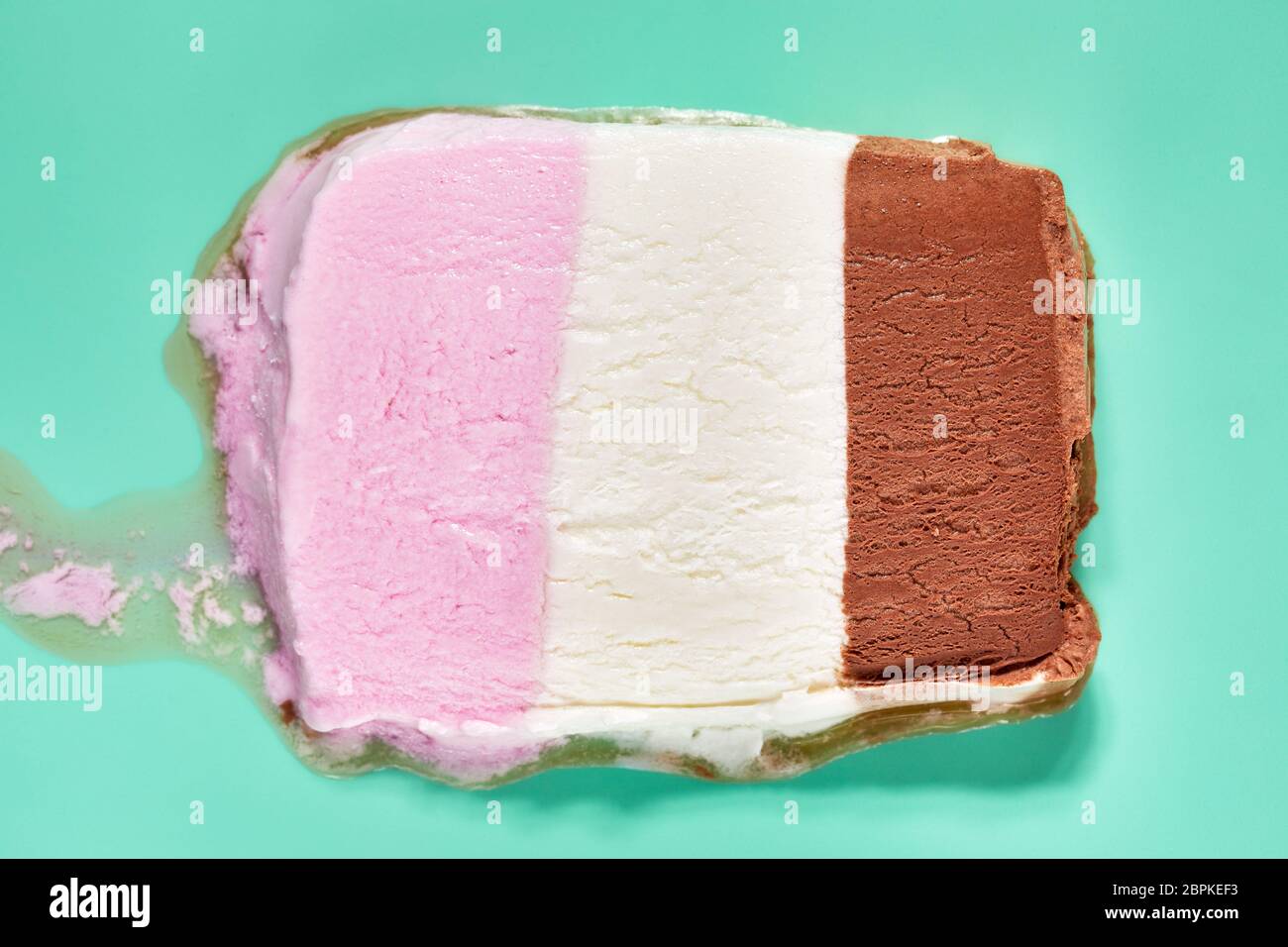 Slice of Neapolitan ice cream, melted Stock Photo