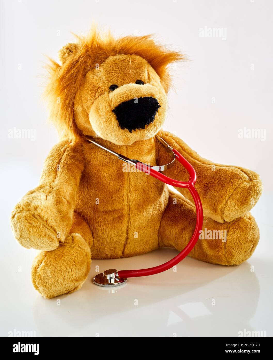 Plush toy lion doctor with stethoscope. Children health care or pediatrician office concept
