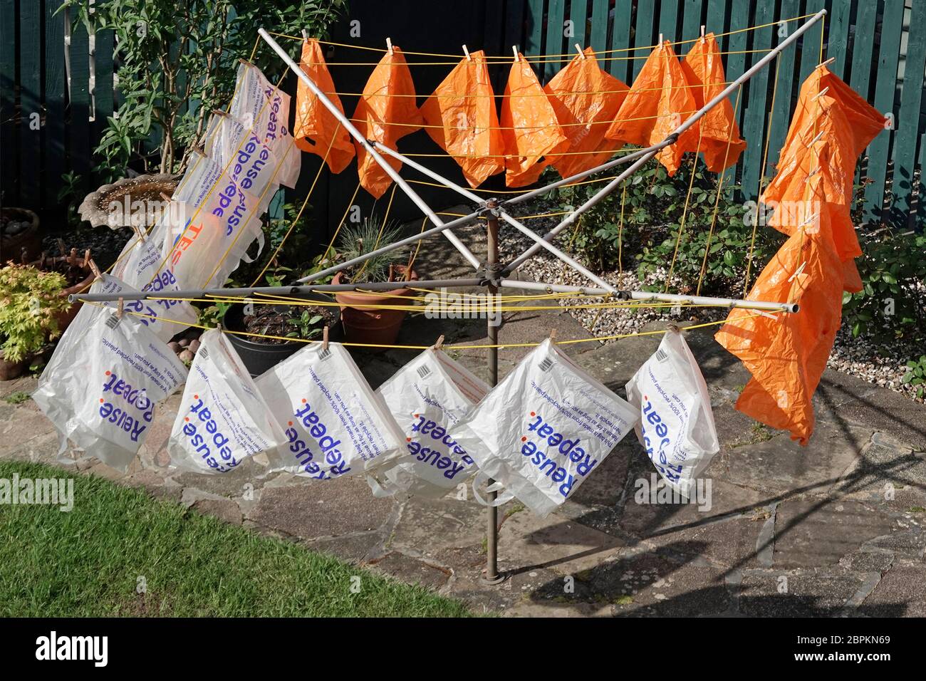 Supermarket recycled plastic reusable carrier bag dry outdoors after soapy water wash coronavirus precaution supplied with online shopping delivery UK Stock Photo