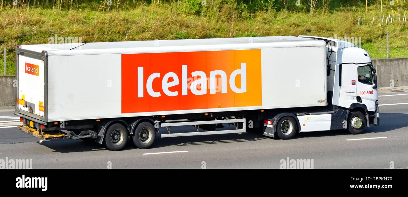Side view of Iceland frozen foods & groceries retail business food supply chain hgv delivery lorry truck & brand advertising on trailer  UK motorway Stock Photo