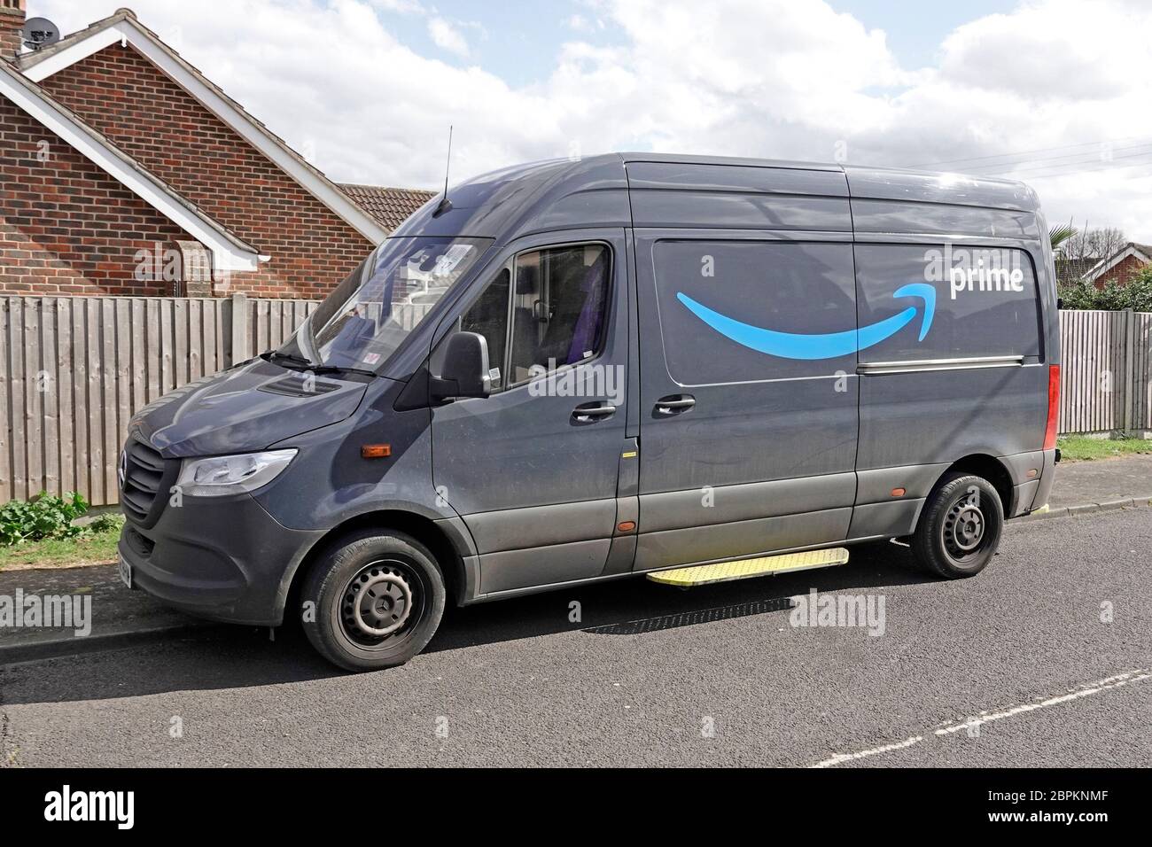 Front & side view of Mercedes Benz Sprinter van with Amazon Prime brand  business logo parked partly on pavement driver makes home parcel delivery  UK Stock Photo - Alamy