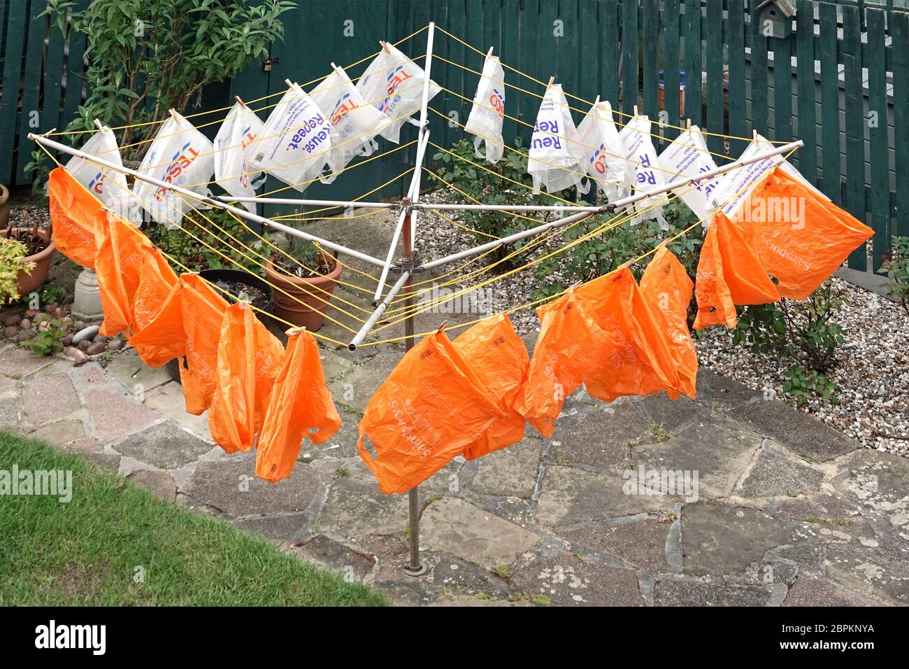 Recycled plastic shopping carrier bags given by supermarket for home delivery of online grocery orders  washed dried & made coronavirus safe reusable Stock Photo