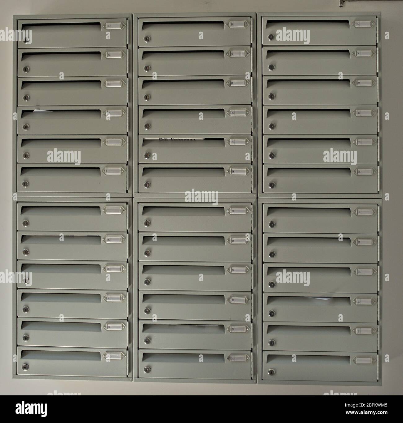 Rows of Mail Boxes in Building on white Wall Stock Photo - Alamy