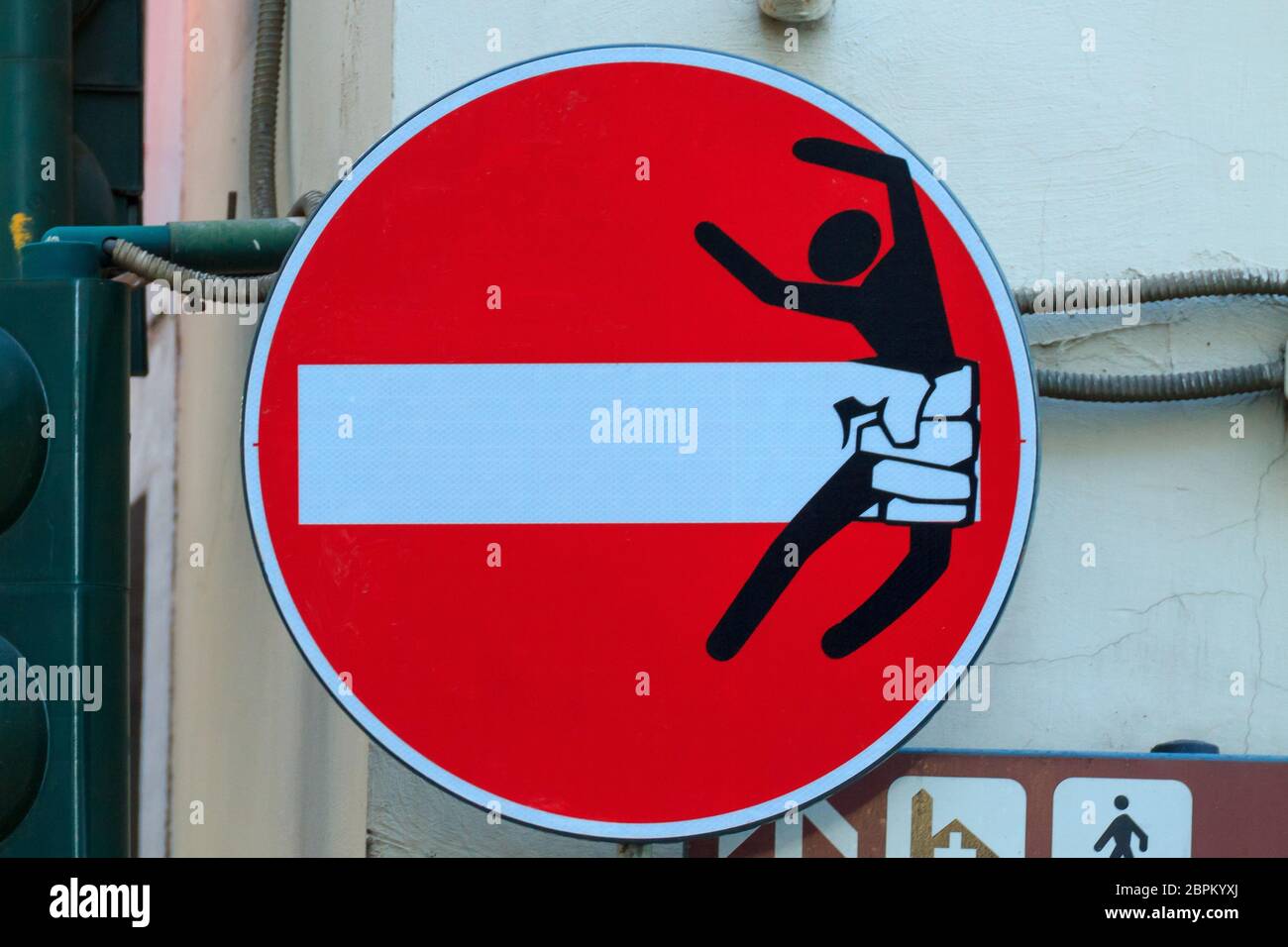 Road sign with an hand that break out the signal, street art ...