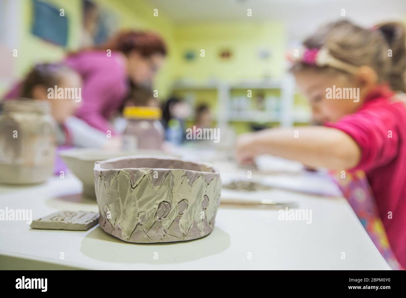 Little artists working with clay at pottery workshop Stock Photo - Alamy