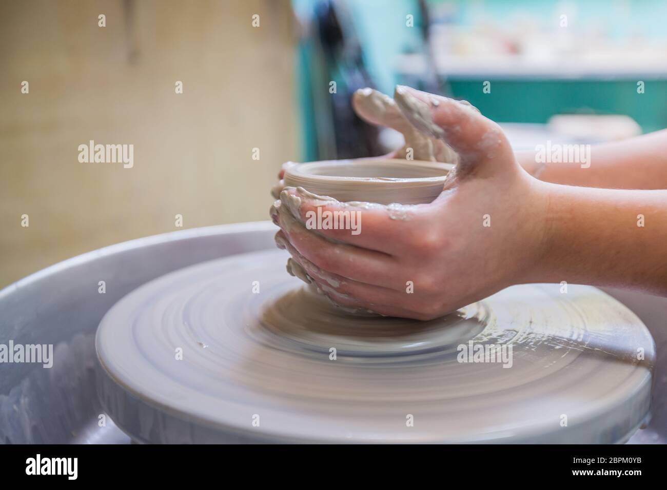 Child potters hands molding clay on wheel at workshop Stock Photo - Alamy