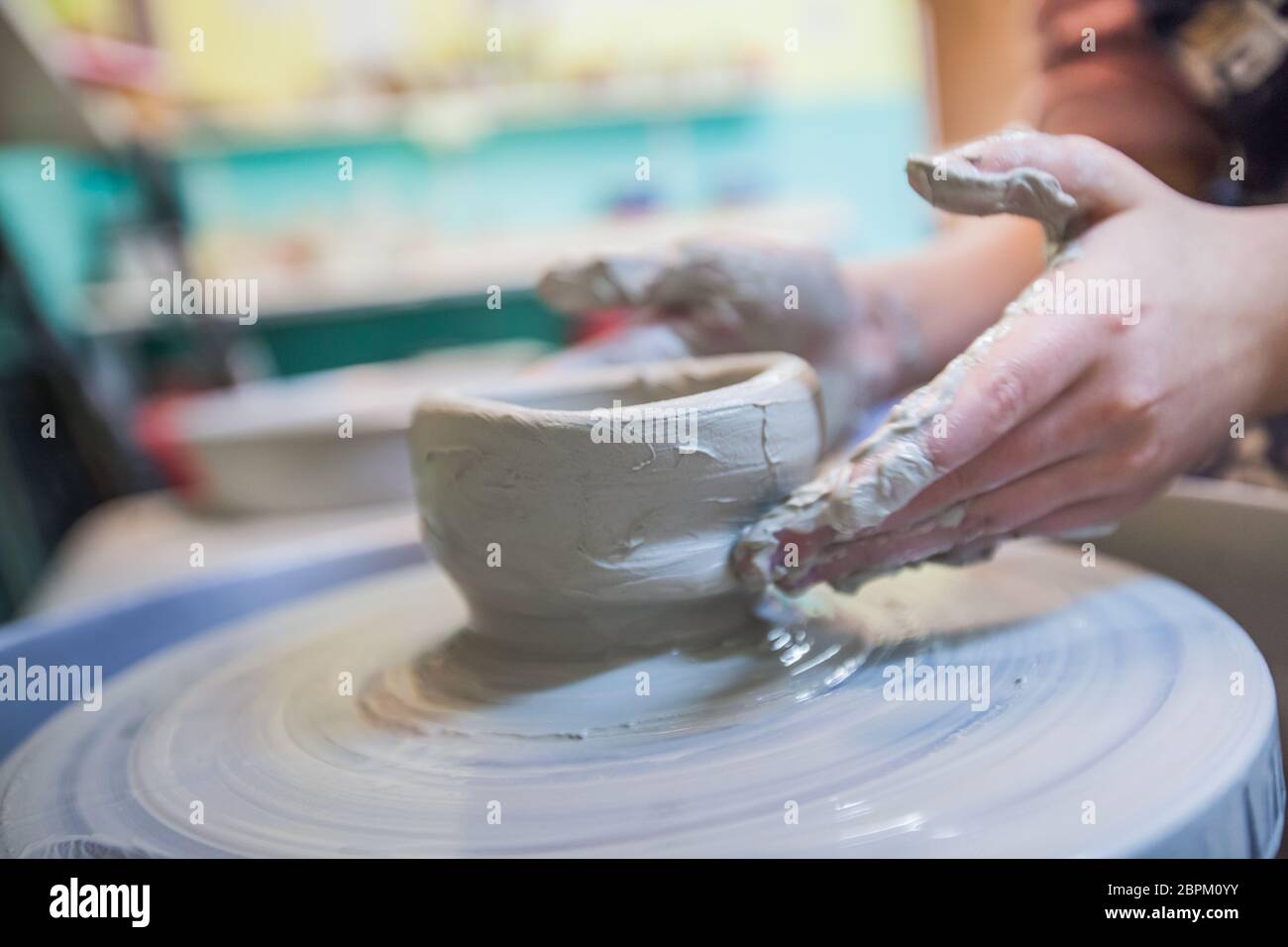 Child potters hands molding clay on wheel at workshop Stock Photo - Alamy