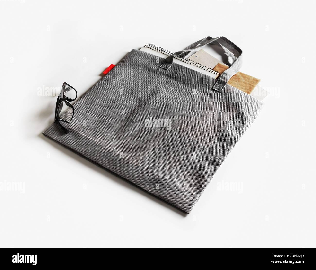 Blank gray shopping bag on white paper background Stock Photo - Alamy