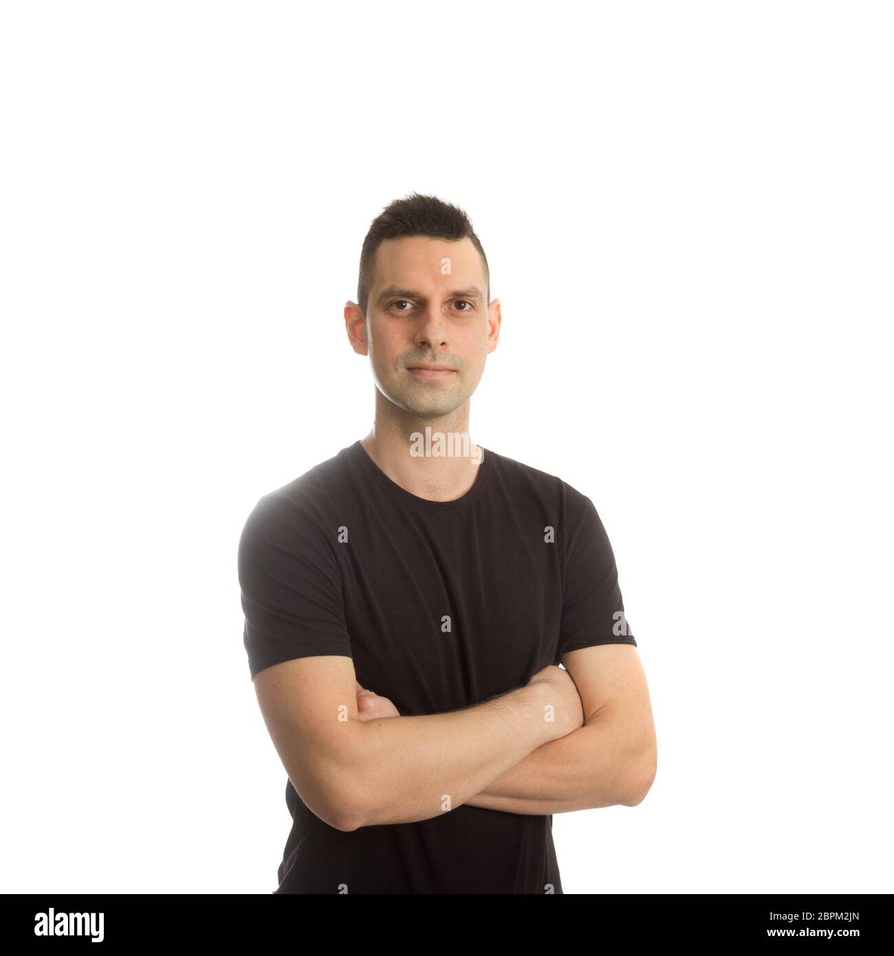 Casual young man looking at camera with arms crossed Stock Photo - Alamy