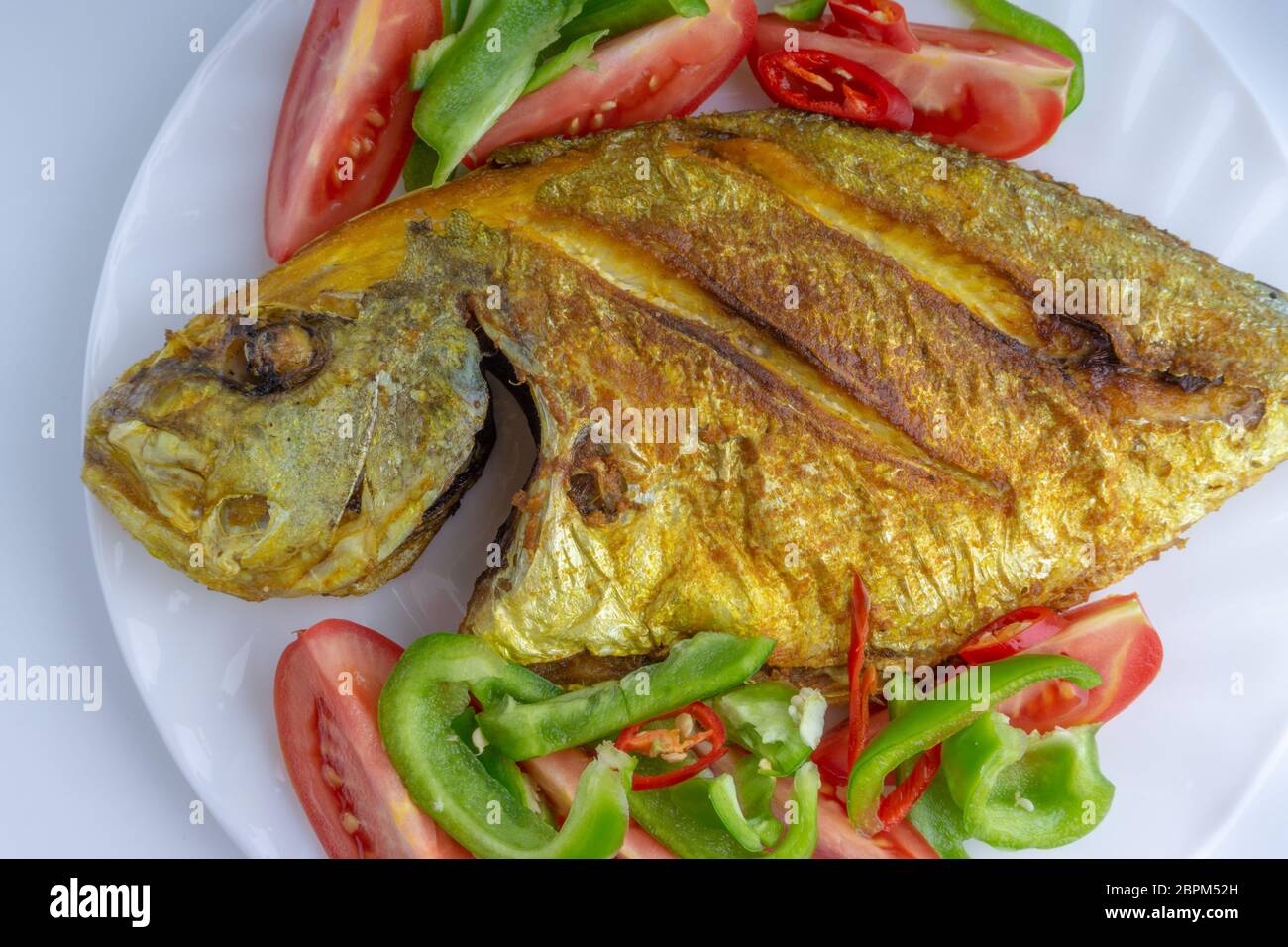 Fried fish on white background with selective focus Stock Photo - Alamy