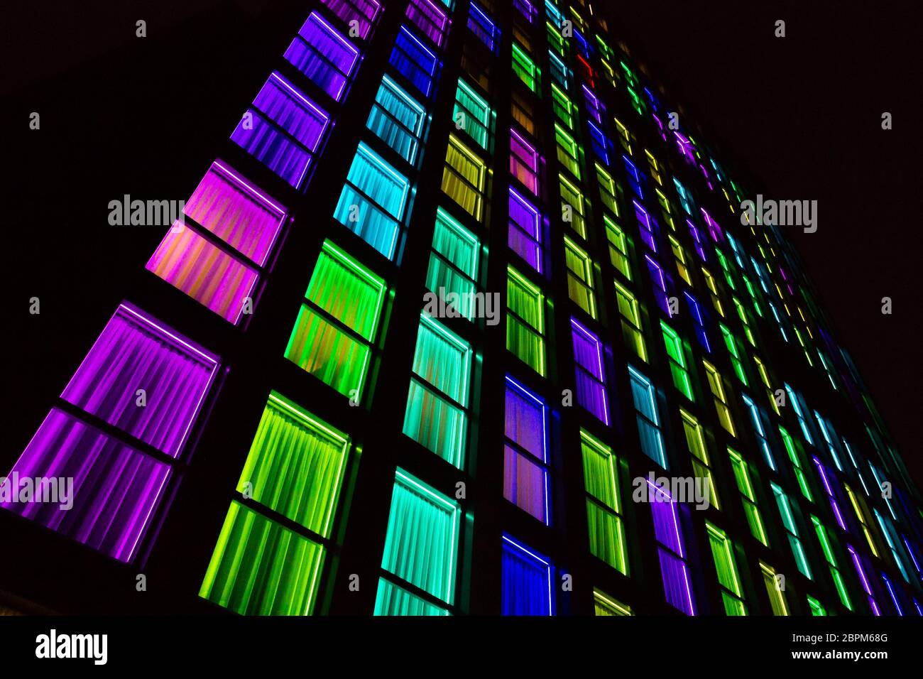 Colored windows texture. Windows illuminated by neon lights background ...