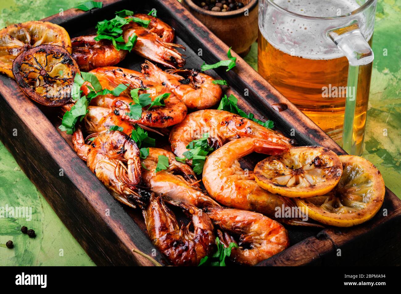 Roasted shrimps and lemon on cutting board.Seafood, shelfish Stock Photo