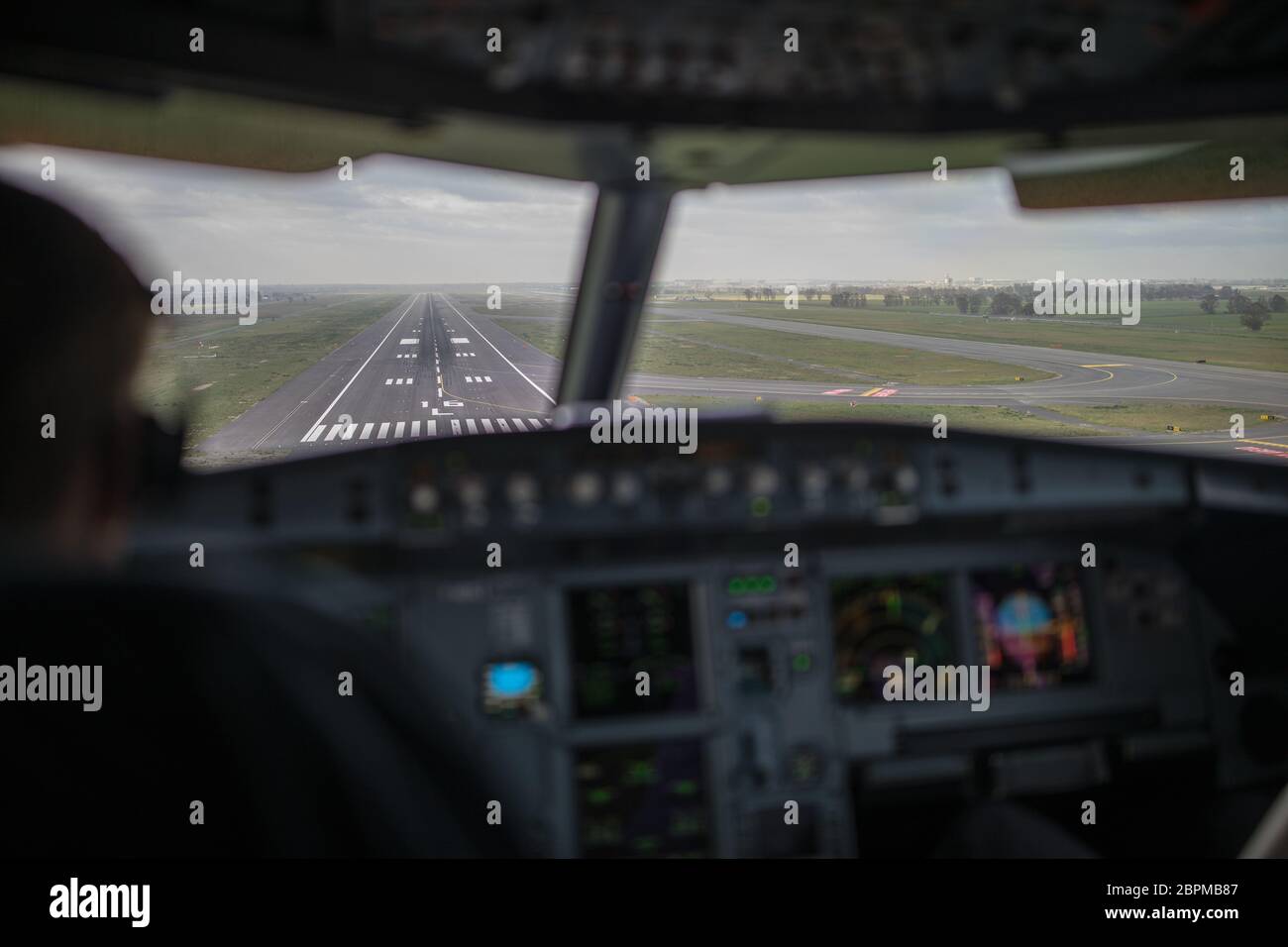 Pilot's hand accelerating on the throttle in a commercial airliner ...