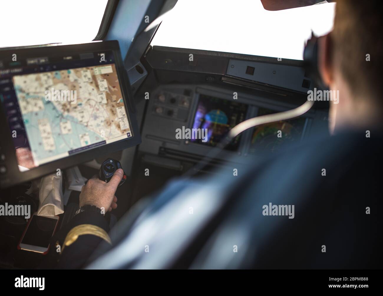 Pilot's hand accelerating on the throttle in a commercial airliner ...